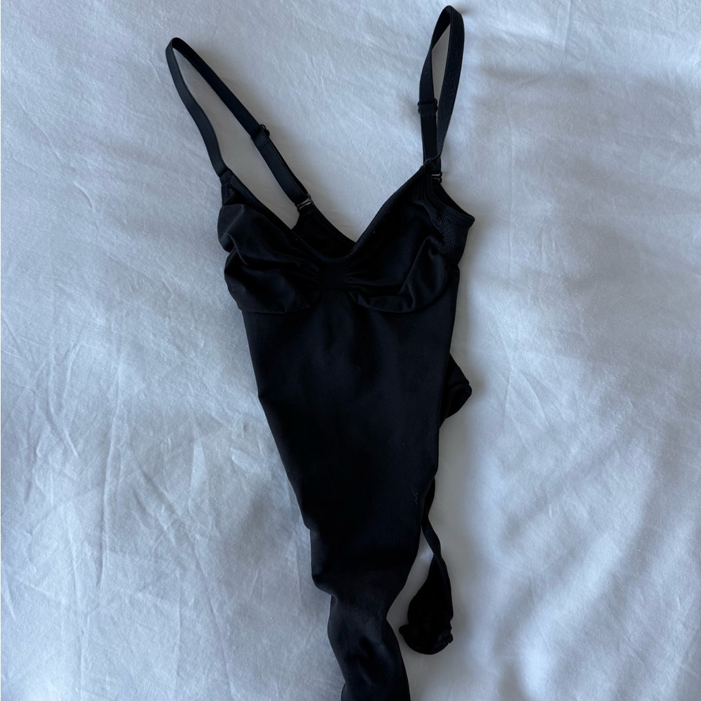 Skims iconic black body on stretchy bodysuit